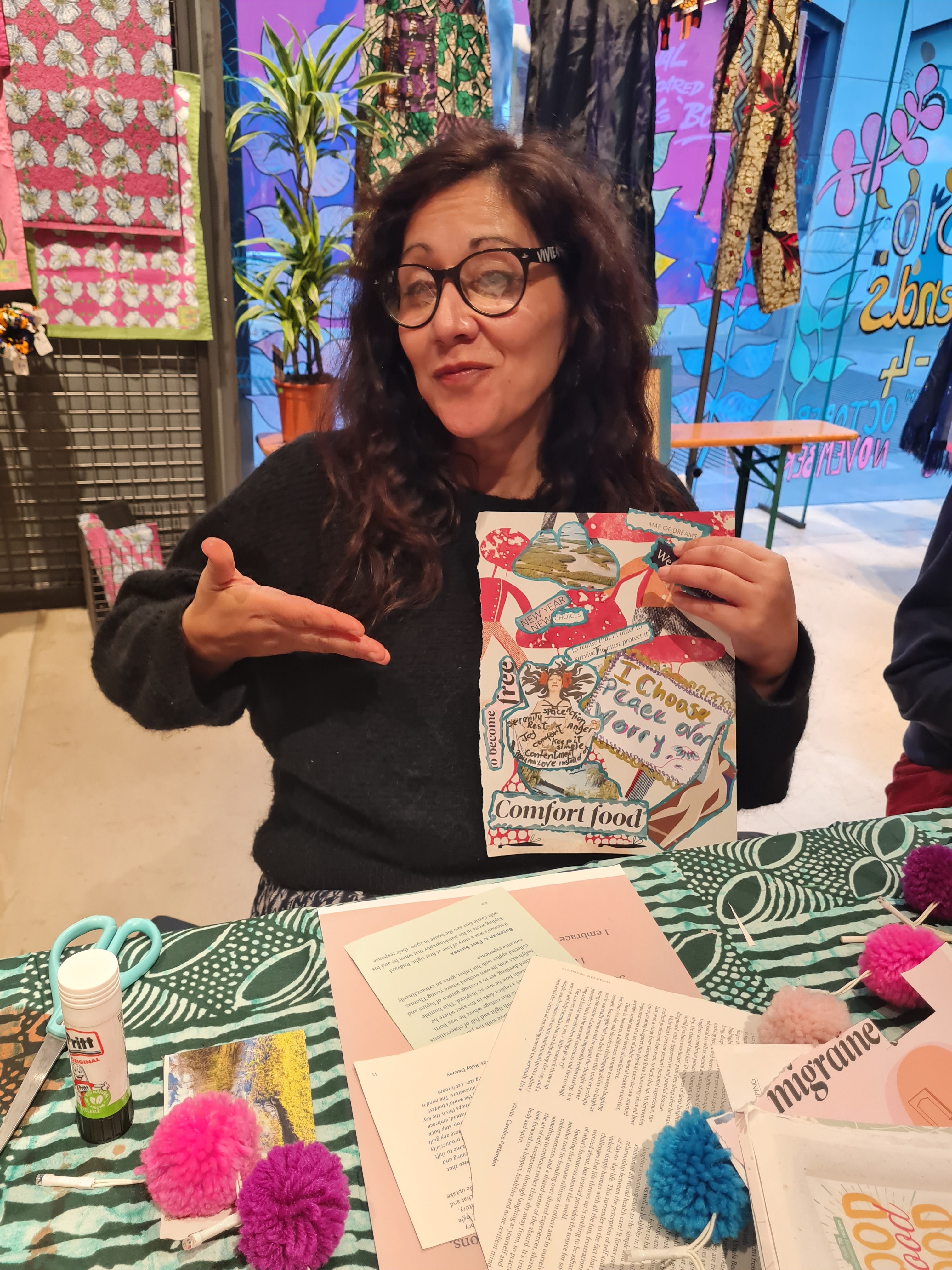 Person holding a colorful book in front of a vibrant, multicolored background